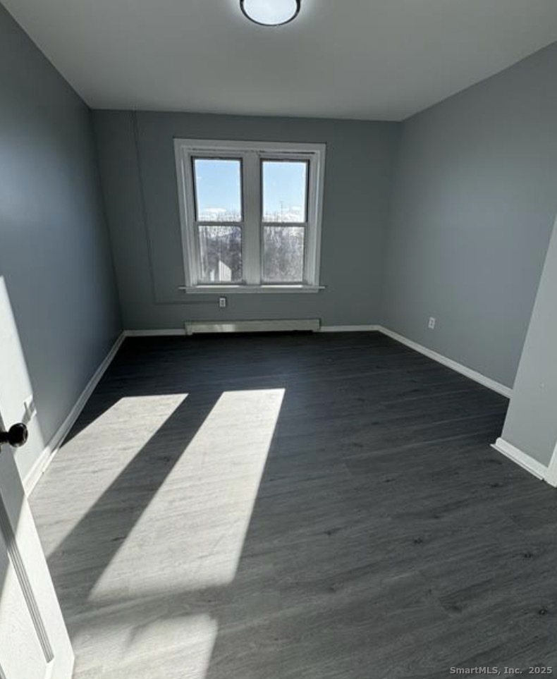 511 East Main Street Bridgeport, CT 06608 - Photo 2 of 6 an empty room with wooden floor and windows