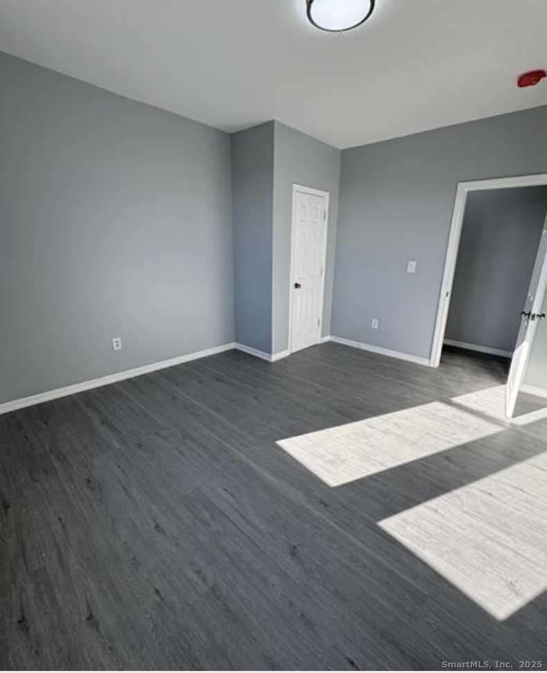 511 East Main Street Bridgeport, CT 06608 - Photo 3 of 6 an empty room with wooden floor and windows