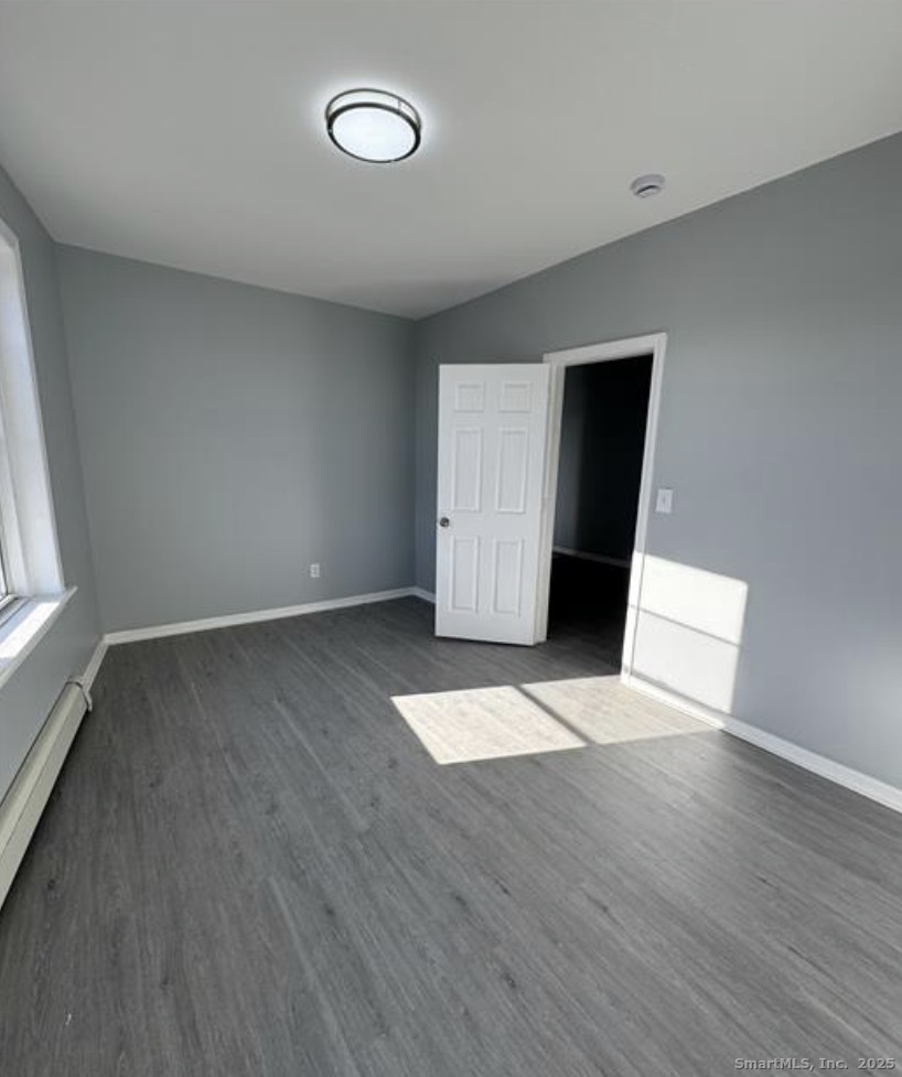 511 East Main Street Bridgeport, CT 06608 - Photo 5 of 6 a view of empty room with wooden floor and fan