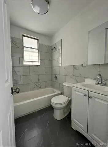 a bathroom with a toilet sink and bathtub