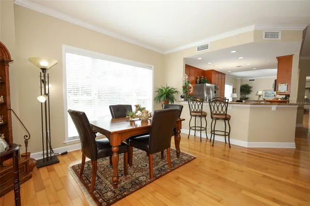 a bedroom with a bed and a lamp on the dresser