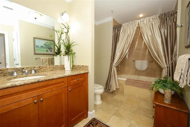 a white toilet sitting next to a bathroom sink