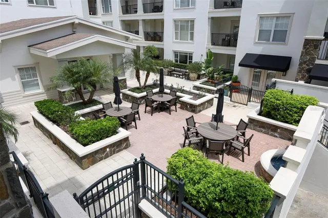 a kitchen with stainless steel appliances granite countertop a refrigerator a sink dishwasher a stove and a microwave oven