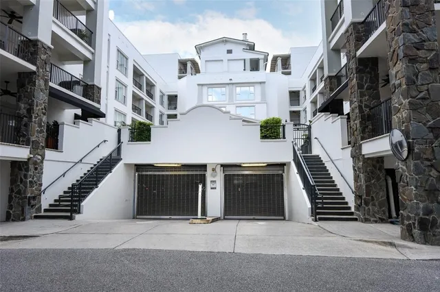 a living room with furniture gym equipment and a large window