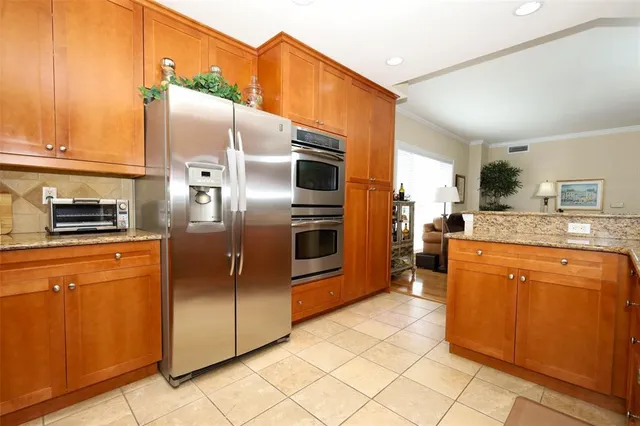 a kitchen with a sink cabinets and stainless steel appliances