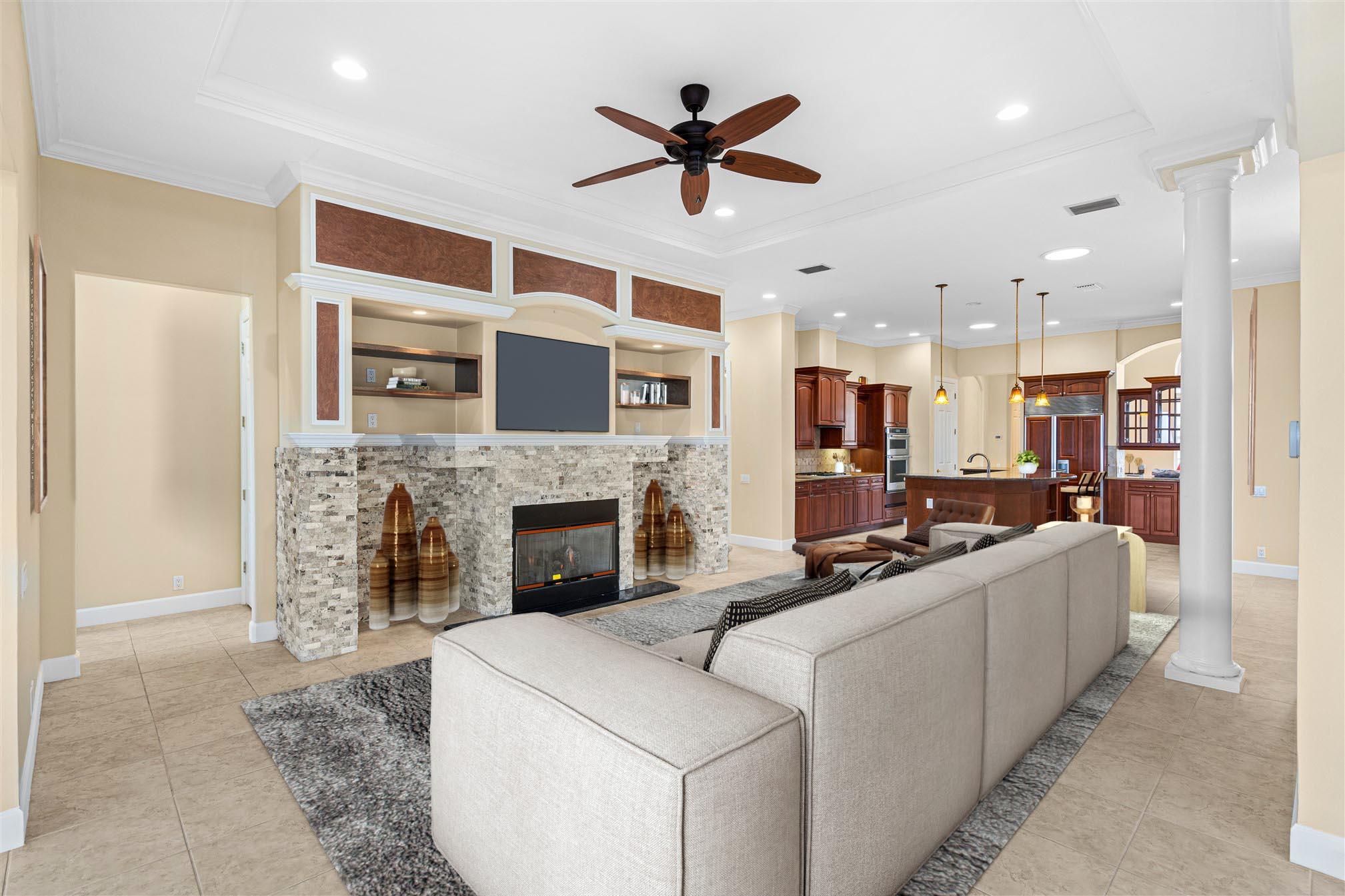 2863 BELLWIND Circle Rockledge, FL 32955 - Photo 26 of 79 a living room with furniture a fireplace and a ceiling fan