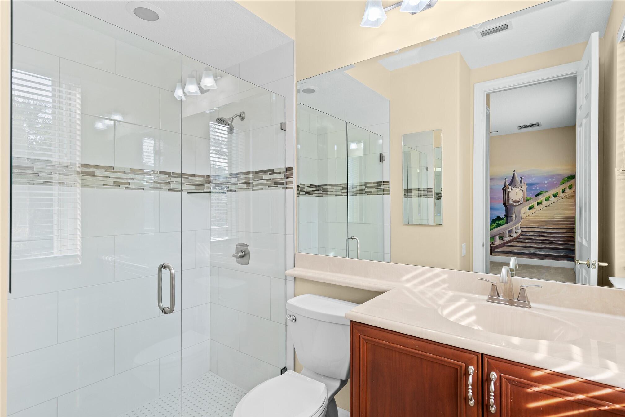 2863 BELLWIND Circle Rockledge, FL 32955 - Photo 44 of 79 a bathroom with a granite countertop sink mirror vanity and toilet