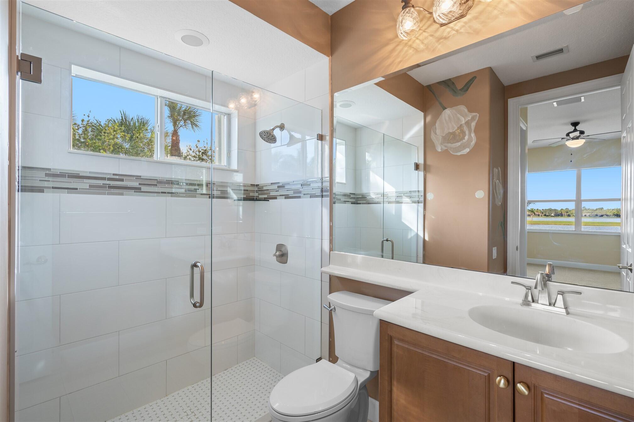 2863 BELLWIND Circle Rockledge, FL 32955 - Photo 46 of 79 a bathroom with a granite countertop sink toilet and shower