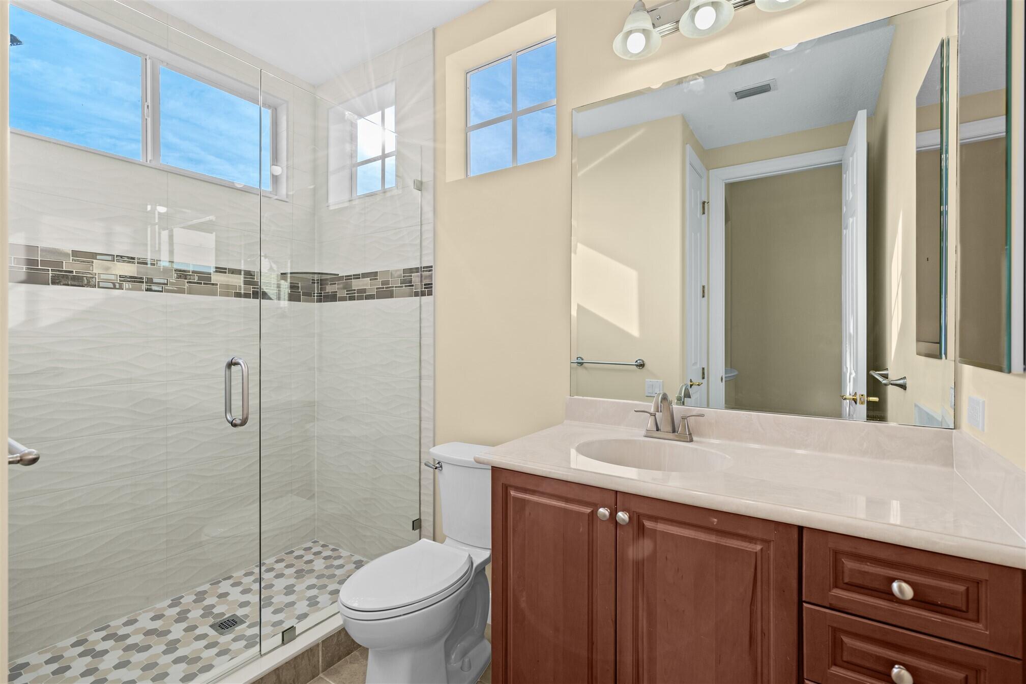 2863 BELLWIND Circle Rockledge, FL 32955 - Photo 53 of 79 a bathroom with a granite countertop sink a toilet a mirror and shower