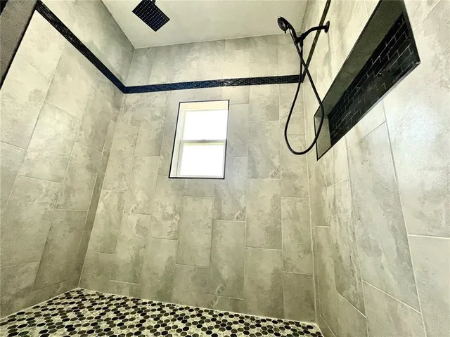 a bathroom with a black and white shower