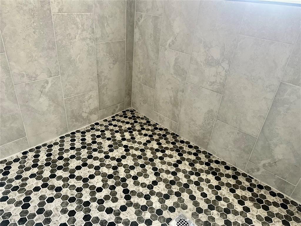 314 15th Avenue Ocoee, FL 34761 - Photo 12 of 37 a bathroom with a black and white shower