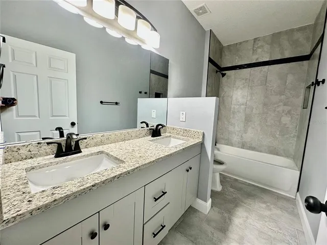 a bathroom with a shower and a bath tub