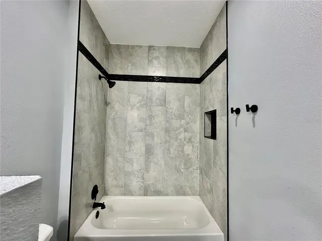 a bathroom with a shower and a sink