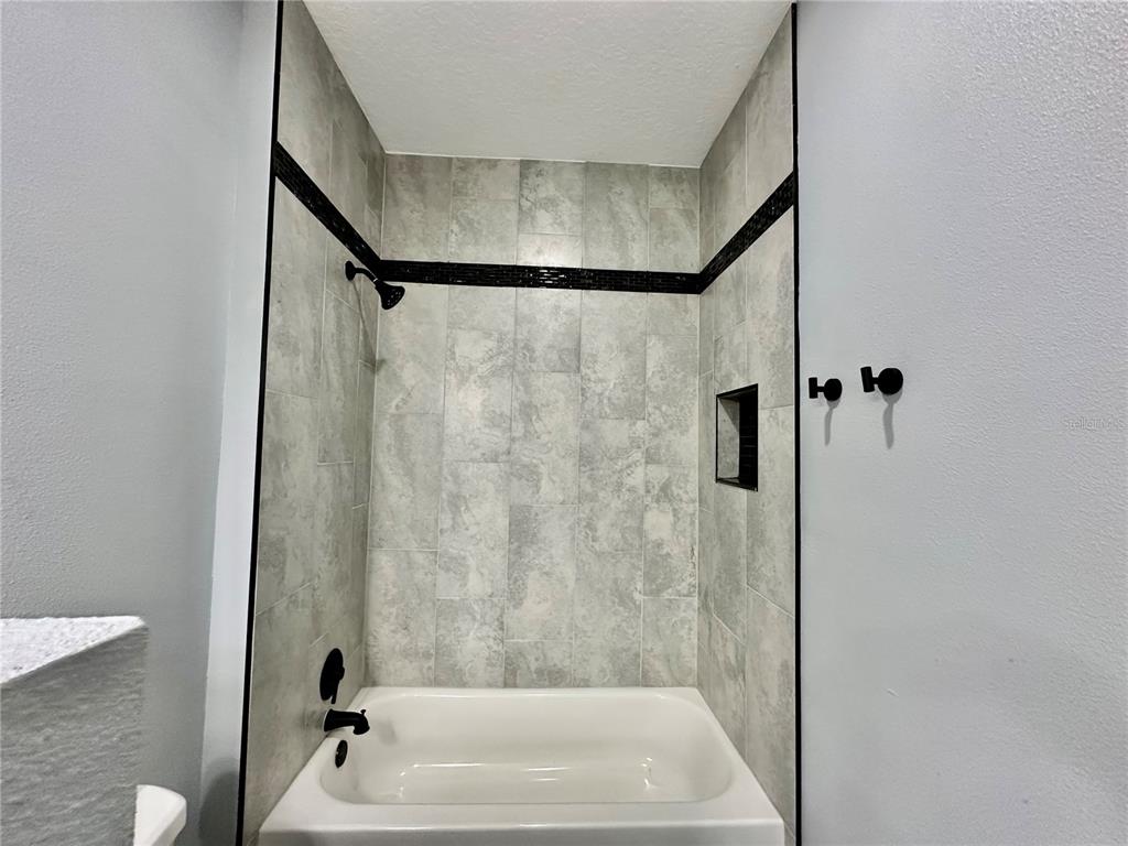 314 15th Avenue Ocoee, FL 34761 - Photo 14 of 37 a bathroom with a shower and a bath tub