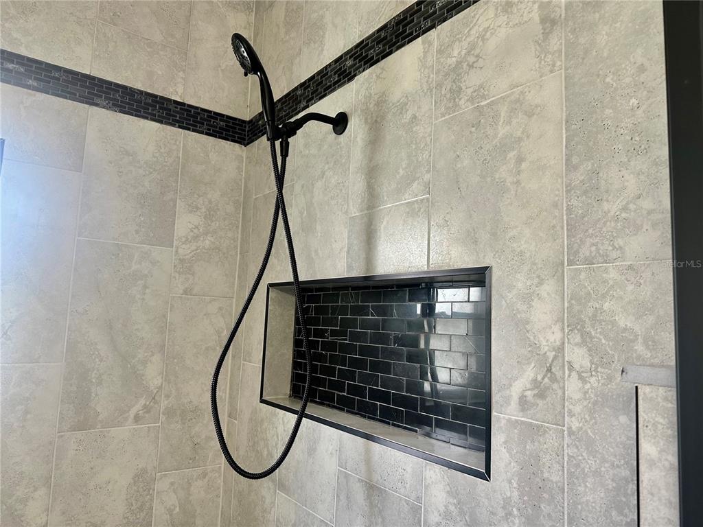 314 15th Avenue Ocoee, FL 34761 - Photo 17 of 37 a bathroom with a glass shower door