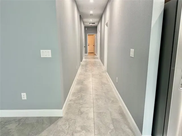 a view of an empty room with a ceiling fan