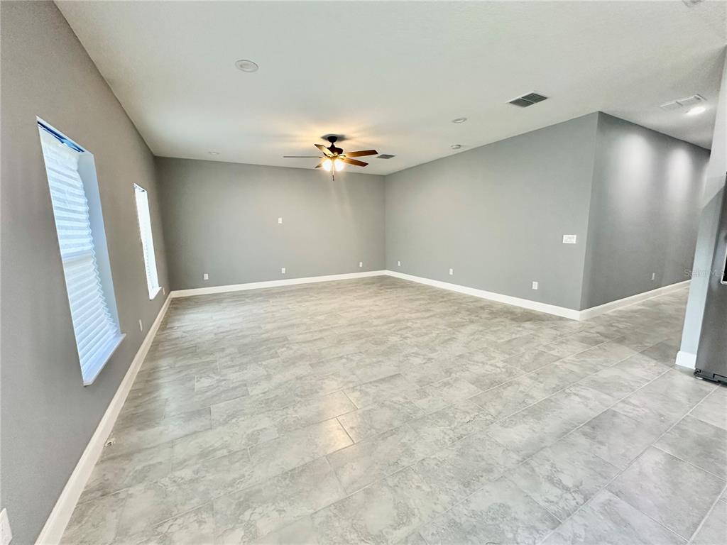 314 15th Avenue Ocoee, FL 34761 - Photo 26 of 37 a view of an empty room with a ceiling fan