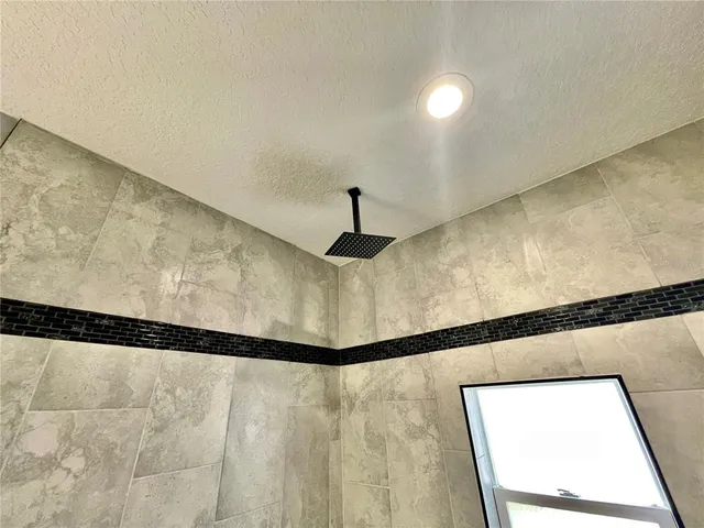 a view of a room with a ceiling fan and a window