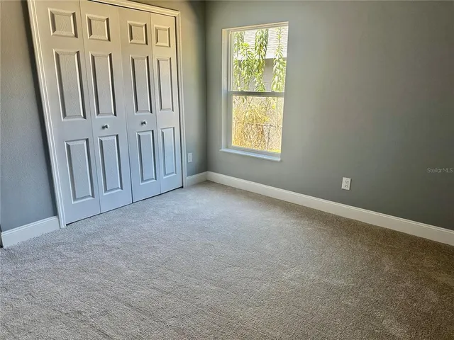 a large bathroom with a large tub shower hardwood and floor to ceiling window
