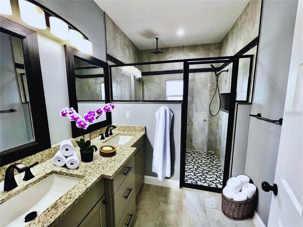 314 15th Avenue Ocoee, FL 34761 - Photo 9 of 37 a bathroom with a sink mirror and shower