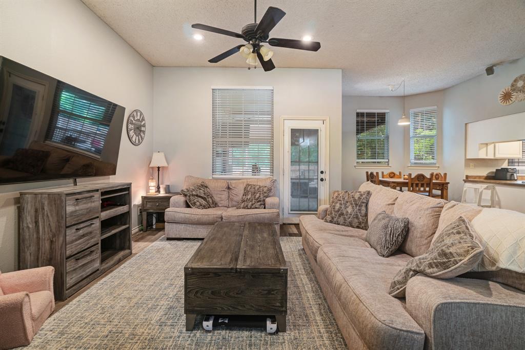 566 Turtle Creek Drive Reno, TX 75462 - Photo 4 of 19 Living area with a textured ceiling, a ceiling fan, and recessed lighting