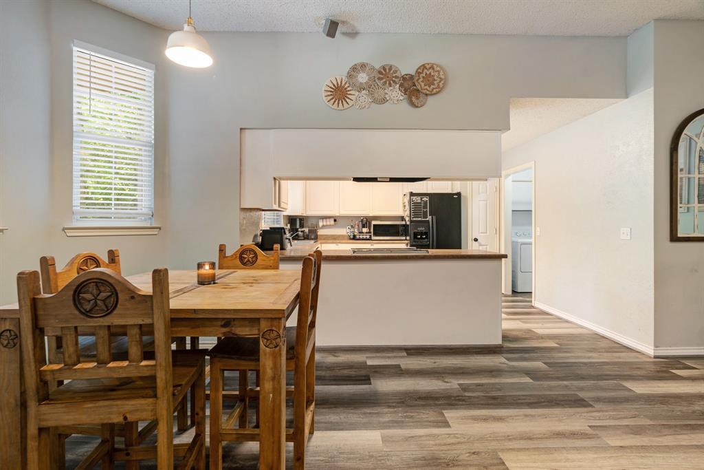 566 Turtle Creek Drive Reno, TX 75462 - Photo 5 of 19 Dining space featuring wood finished floors, washer / clothes dryer, and a textured ceiling