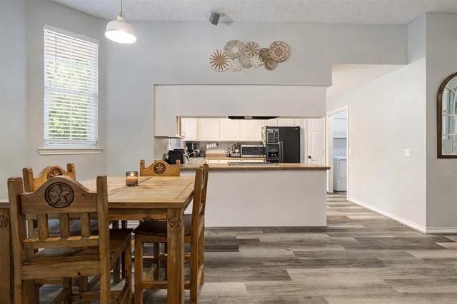 a kitchen with a table and chairs