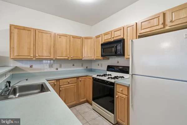 a kitchen with a sink stove and microwave