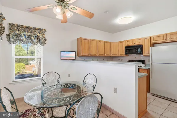 a kitchen with sink a refrigerator and chandelier