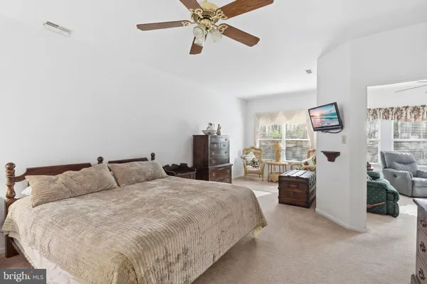 a bedroom with a bed and ceiling fan