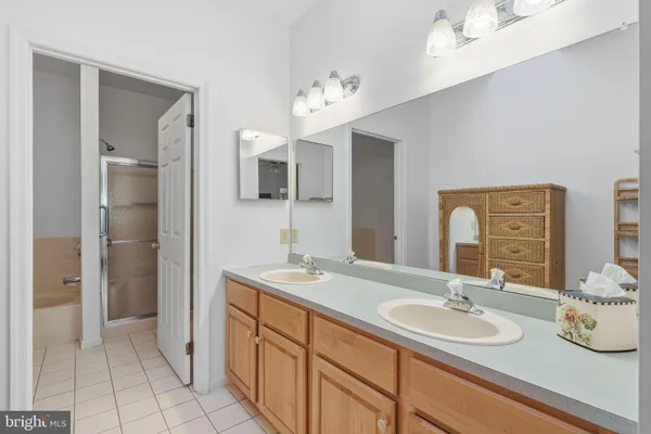 a bathroom with a sink double vanity and a mirror
