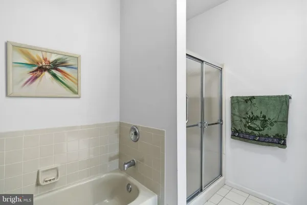 a bathroom with a painting on the wall and shower