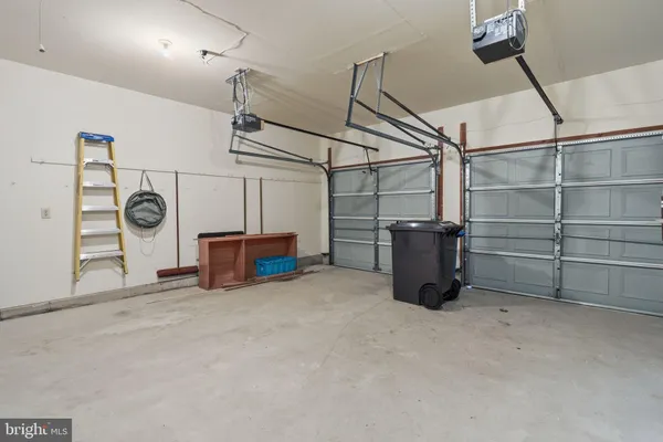 a view of a storage & utility room with multiple dryer and washer
