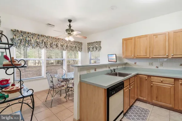 a kitchen with a sink a counter and cabinets