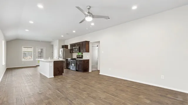 a view of a kitchen with a sink and a refrigerator