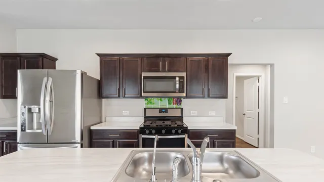 a kitchen with a refrigerator and a sink