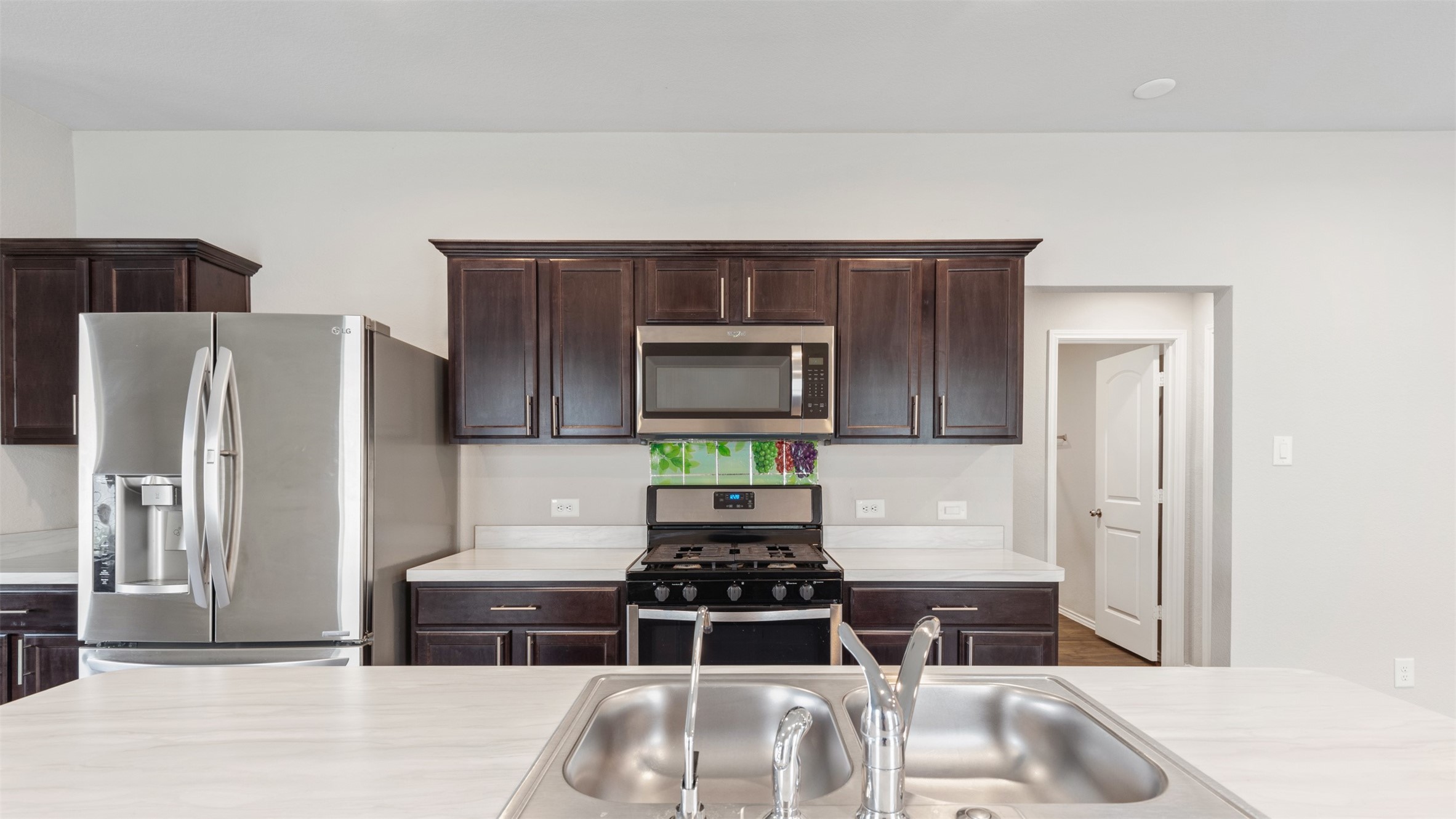2311 Silver Plume Lane Spring, TX 77373 - Photo 9 of 24 a kitchen with a refrigerator and a sink
