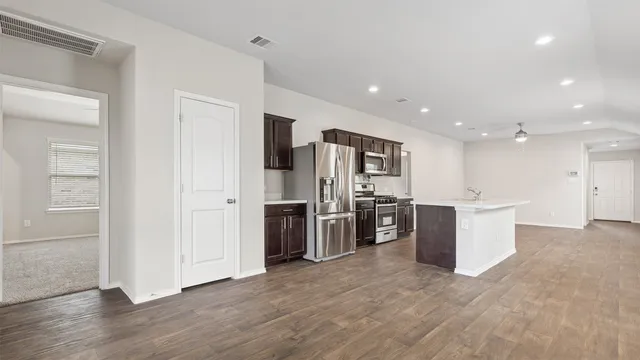 a view of kitchen with stainless steel appliances refrigerator oven and stove