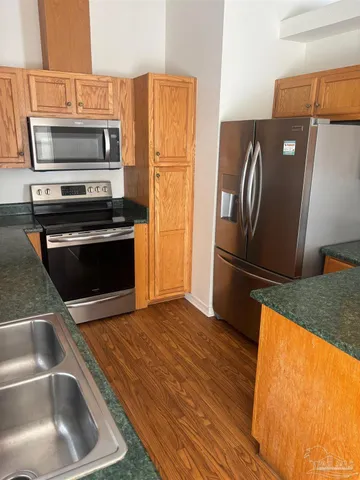 a kitchen with a refrigerator sink and microwave