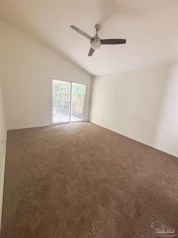 a view of a livingroom with a ceiling fan and window