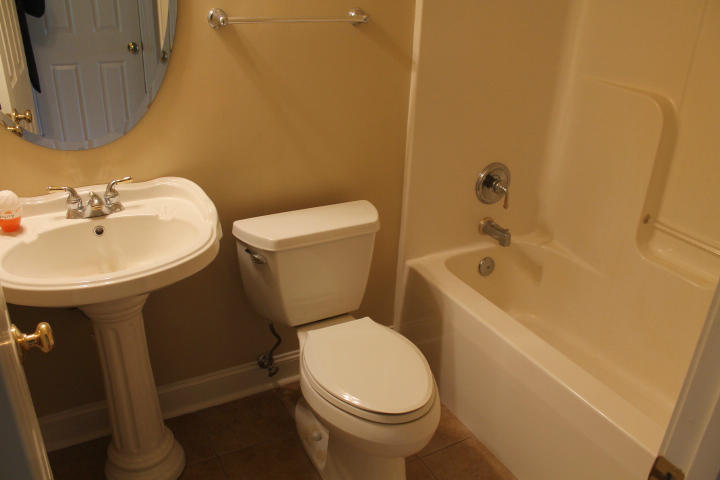 2463 Dillards Hill Road Union Hall, VA 24176 - Photo 10 of 14 a white toilet sitting next to a white sink and vanity