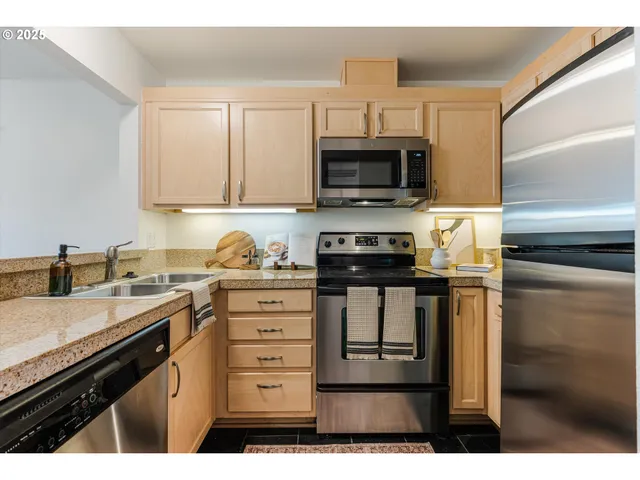 a kitchen with stainless steel appliances a sink stove and microwave