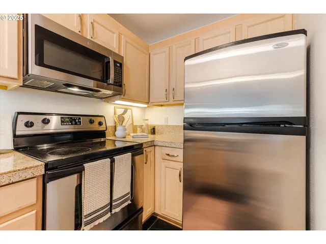 a kitchen with a refrigerator stove and microwave