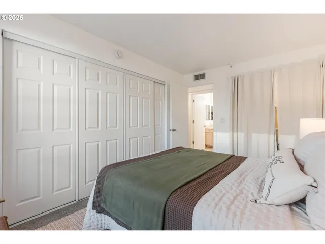 a bedroom with a bed and a painting