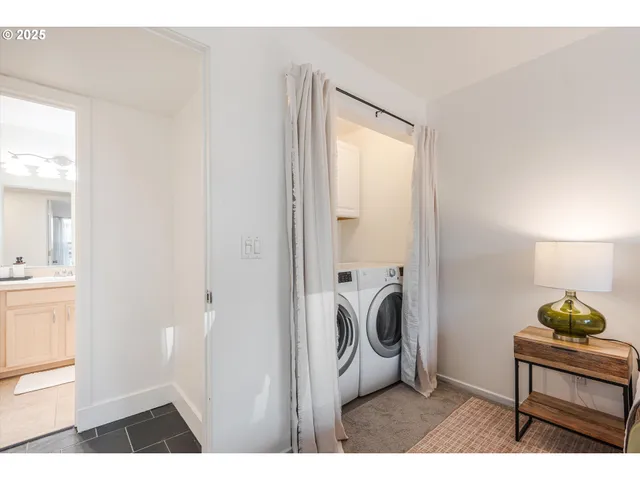 a view of a bedroom with a bed and a window