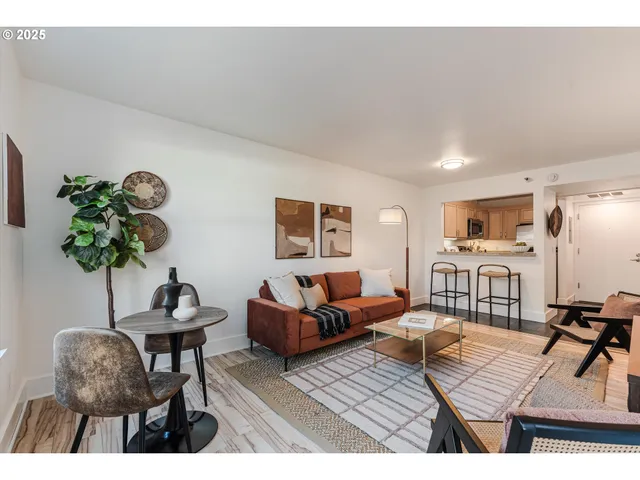 a living room with furniture and a potted plant