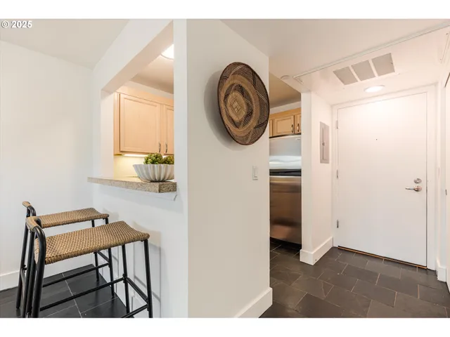 a view of a kitchen with fridge and window