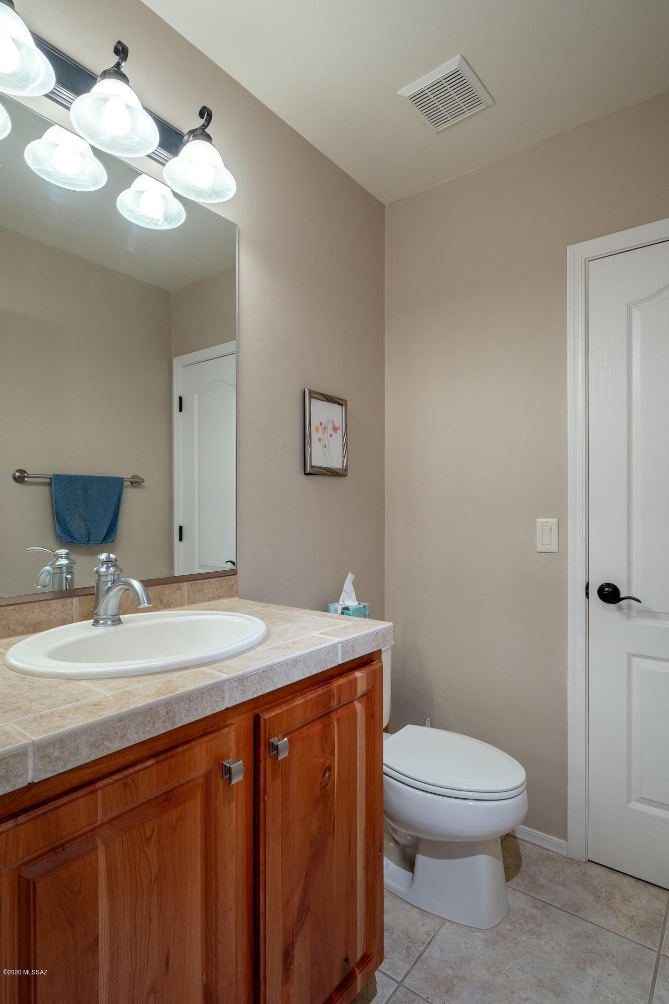 4440 West Crystal Ranch Place Marana, AZ 85658 - Photo 19 of 28 a bathroom with a granite countertop toilet sink and mirror