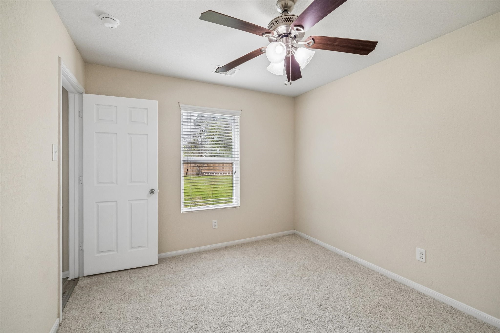 15642 South Fall Fern Circle Houston, TX 77044 - Photo 19 of 25 an empty room with a window and a fan