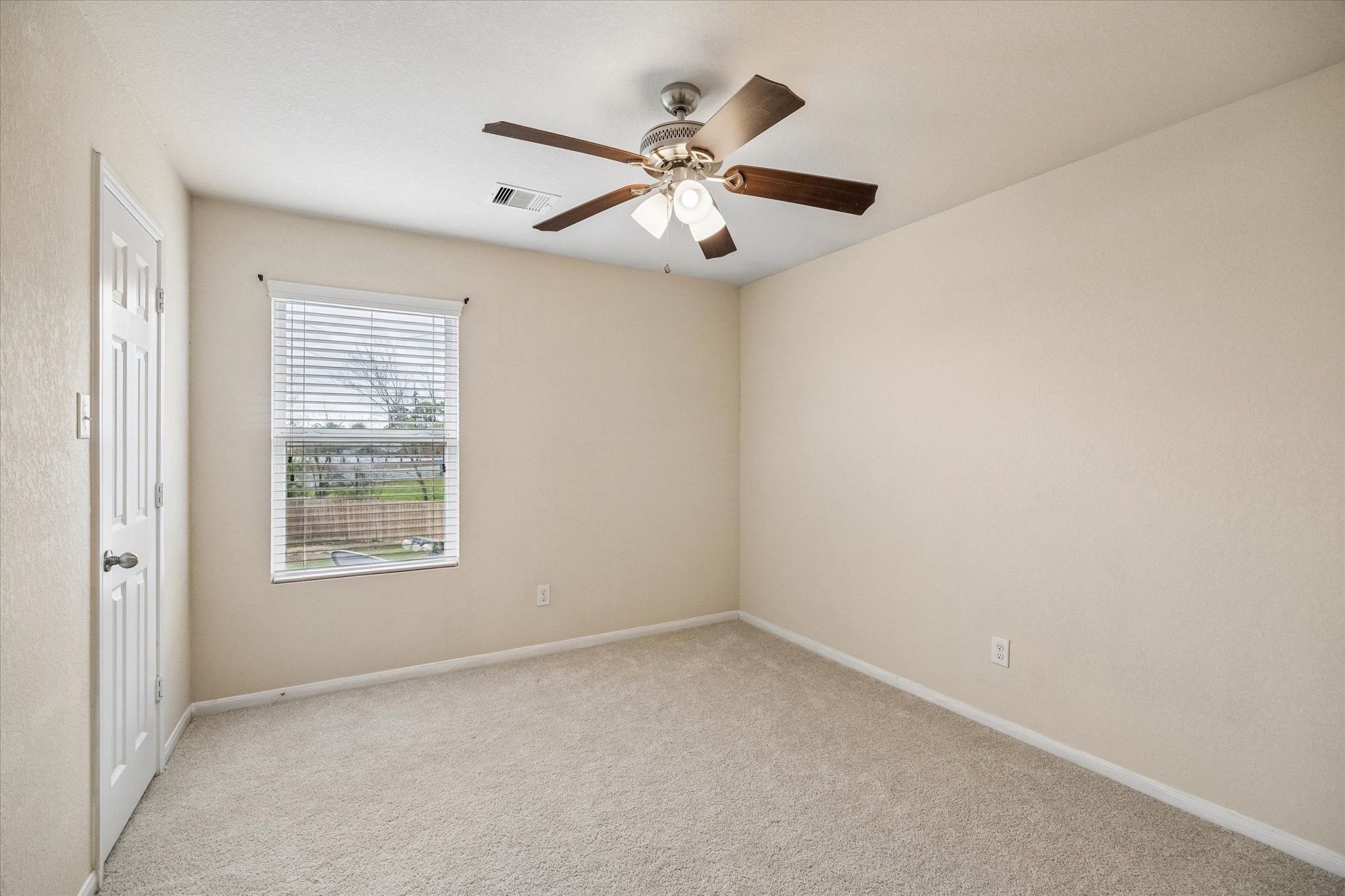15642 South Fall Fern Circle Houston, TX 77044 - Photo 20 of 25 an empty room with a window and a fan